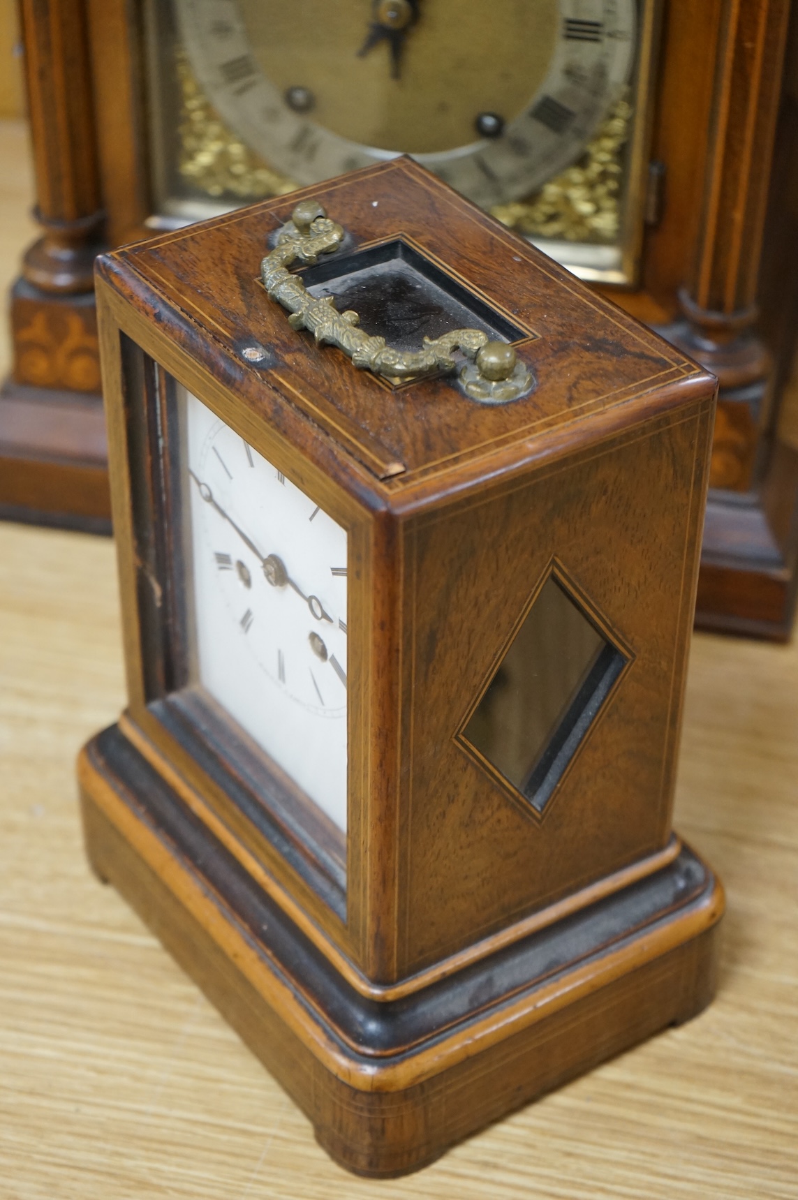 A rosewood mantel clock with French silk suspension movement, together with an Edwardian marquetry bracket clock signed to the dial S.Smith and son, Strand, London with a two train German movement striking on two coiled